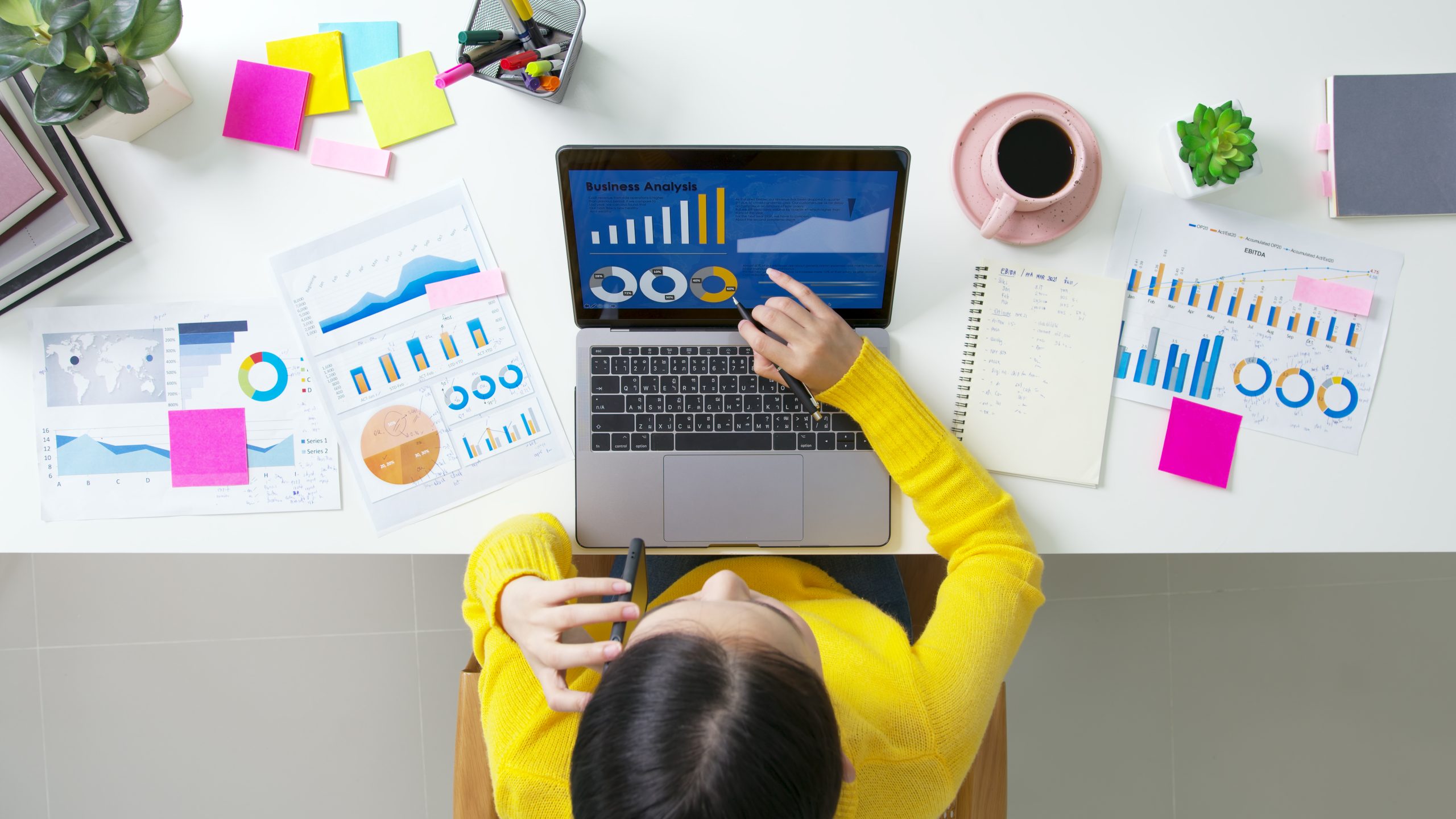 Above top desk of SME owner people home office call talk in SEO chart sale report paper or stock graph big data. Woman remote study MBA digital learn online of job career reskill upskill work plan.