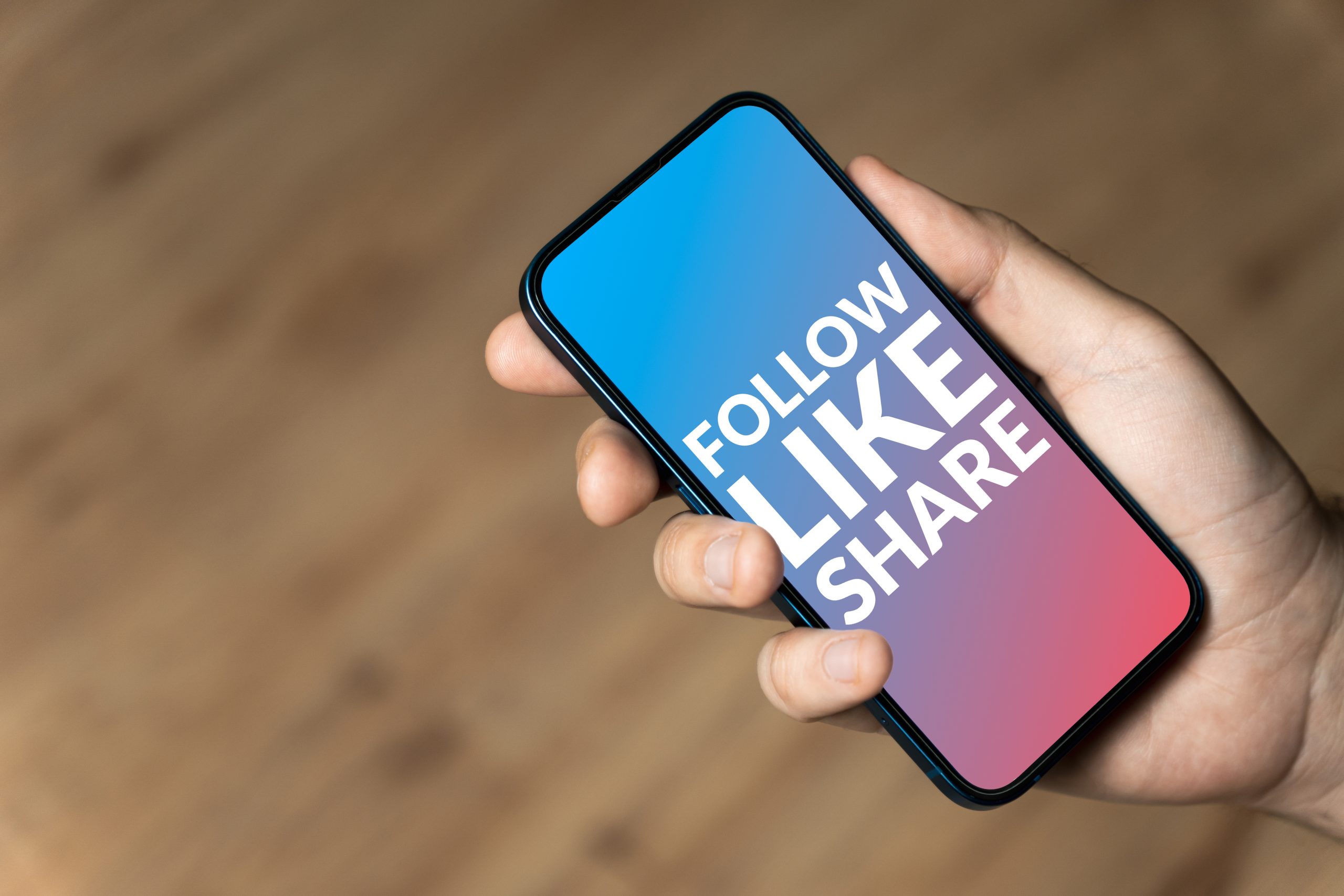 follow-like-share-hand-holding-a-phone-2022-11-10-02-52-43-utc